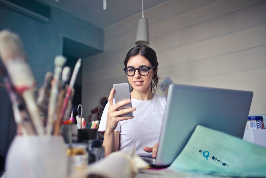 Woman holding up phone while reading lead magnet PDF | North Branch Copywriting Co. 