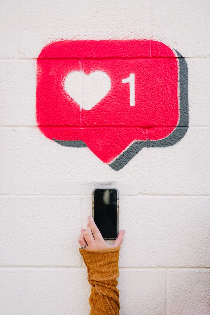 Woman holding up phone while showing love for lead magnet ideas | North Branch Copywriting Co. 