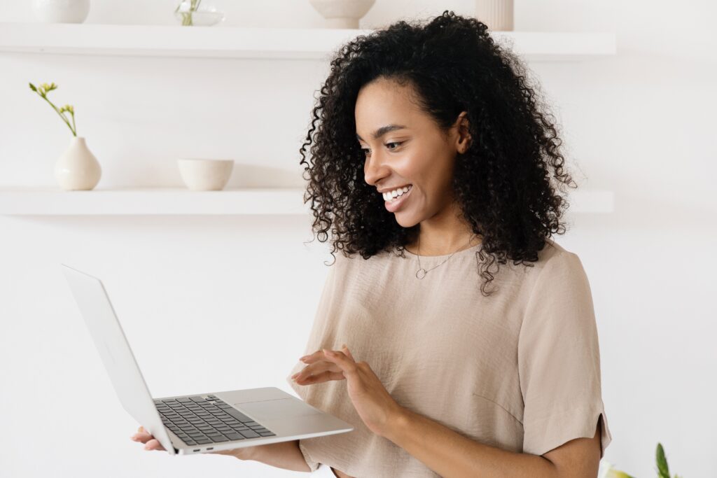 Woman smiling while looking at content repurposing examples | North Branch Copywriting Co. 