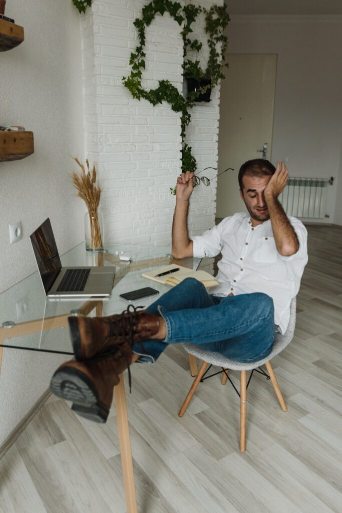 Man at desk with feet up as example of PAS in copywriting example | North Branch Copywriting Co.