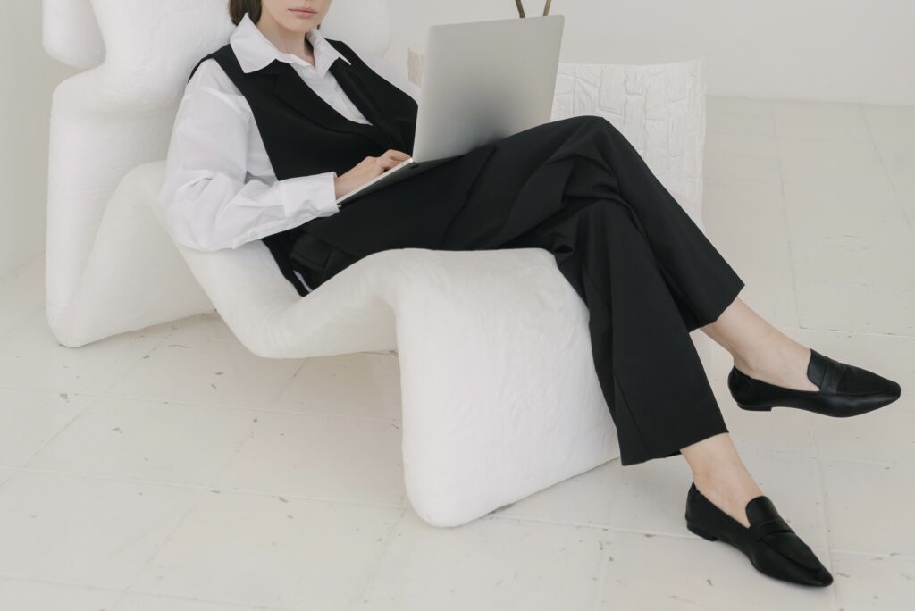 Artistic shot of entrepreneur lounging with computer | North branch Copywriting Studio