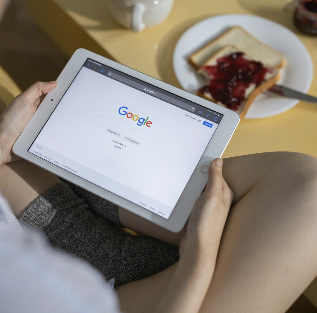 Business owner with a tablet in her lap looking into Google SEO | North Branch Copywriting Studio