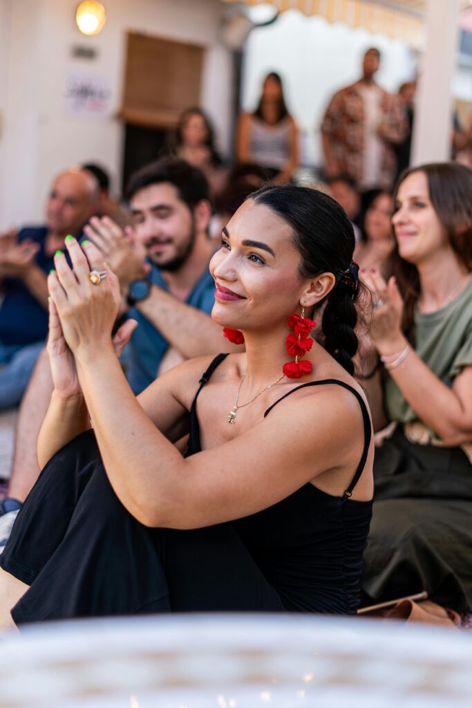 A woman in an audience clapping along to a business idea | North Branch Copywriting Studio